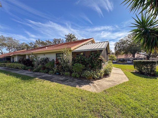 view of property exterior featuring a lawn and stucco siding