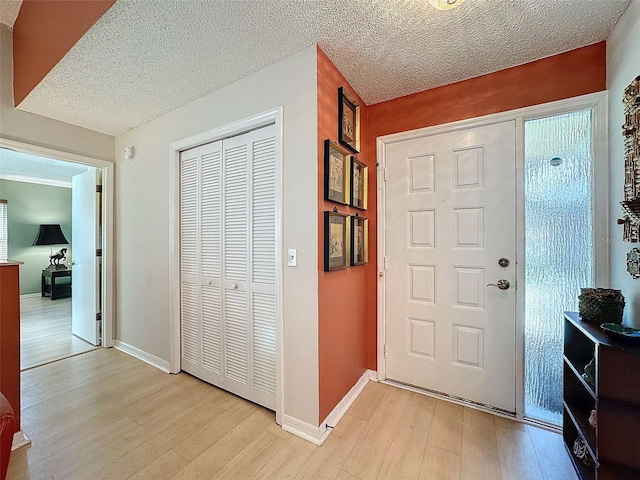 entryway featuring a textured ceiling and light wood-type flooring