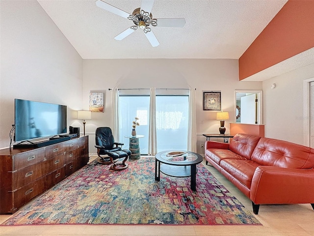 living room with a textured ceiling and ceiling fan