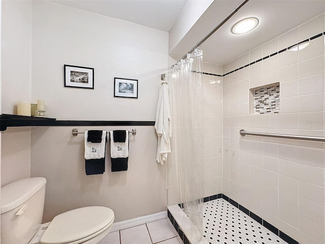 bathroom featuring tile patterned floors, a shower with curtain, and toilet