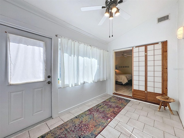 tiled entrance foyer with ceiling fan and lofted ceiling