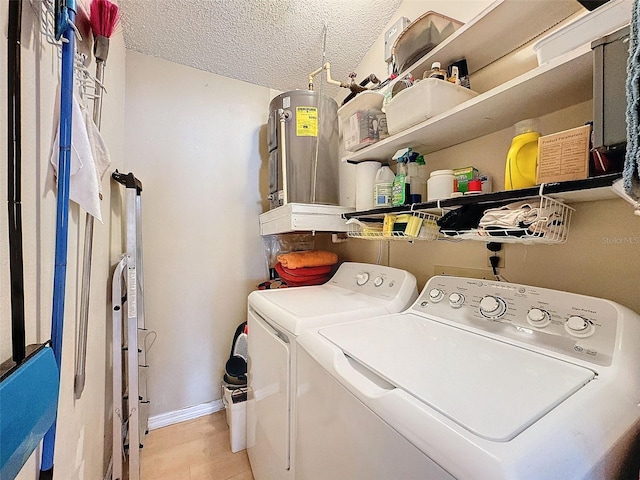 laundry room featuring a textured ceiling and separate washer and dryer