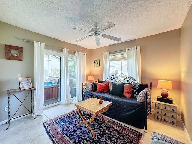 tiled living room with ceiling fan and a textured ceiling