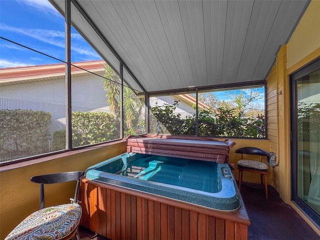 sunroom with a jacuzzi, vaulted ceiling, and wooden ceiling