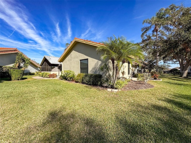 view of home's exterior with a yard