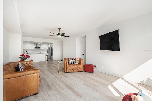 living room featuring light hardwood / wood-style flooring and ceiling fan