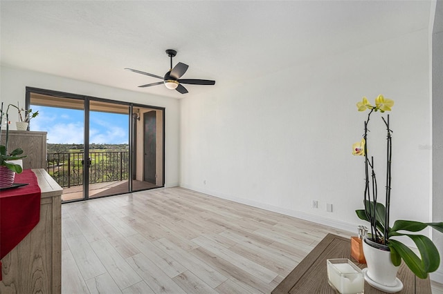 living room with ceiling fan and light hardwood / wood-style floors