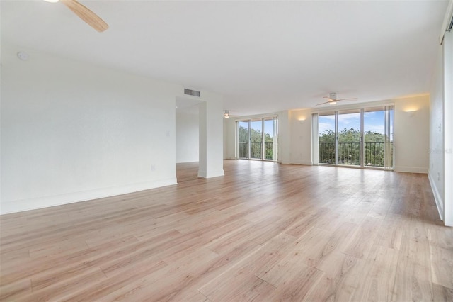 empty room featuring ceiling fan and light hardwood / wood-style flooring