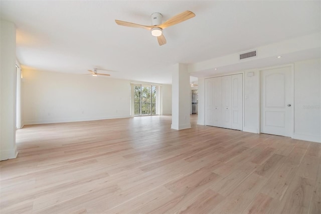 unfurnished living room with ceiling fan and light wood-type flooring