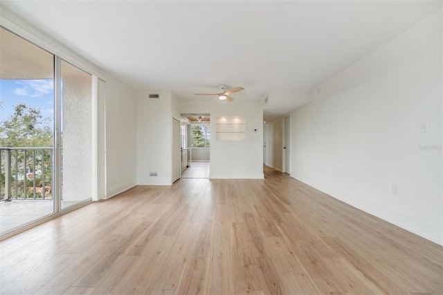 spare room featuring light wood-type flooring and ceiling fan