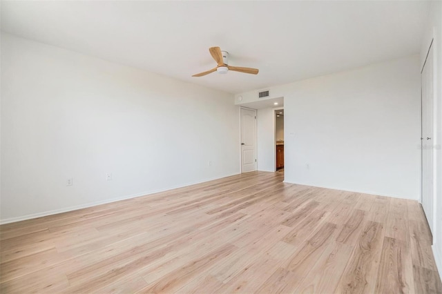 empty room featuring ceiling fan and light wood-type flooring