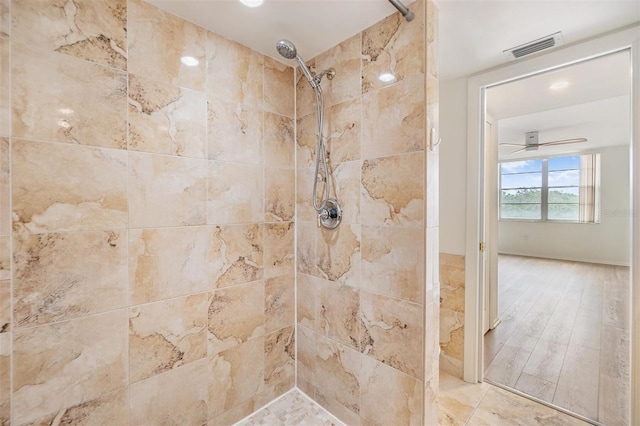 bathroom with tiled shower