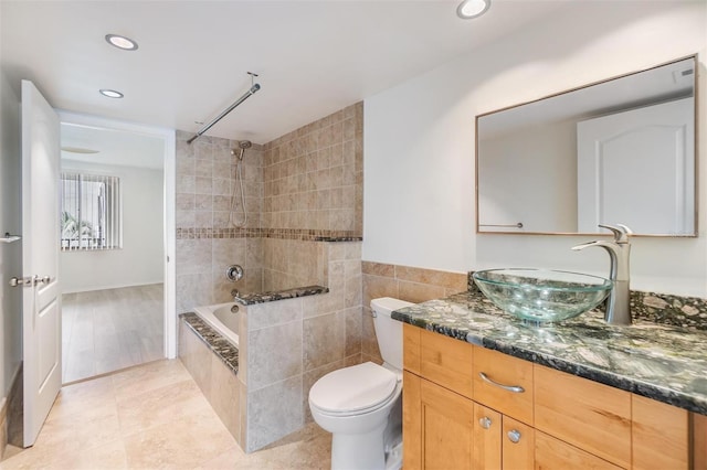 full bathroom with tile patterned flooring, vanity, toilet, and tiled shower / bath