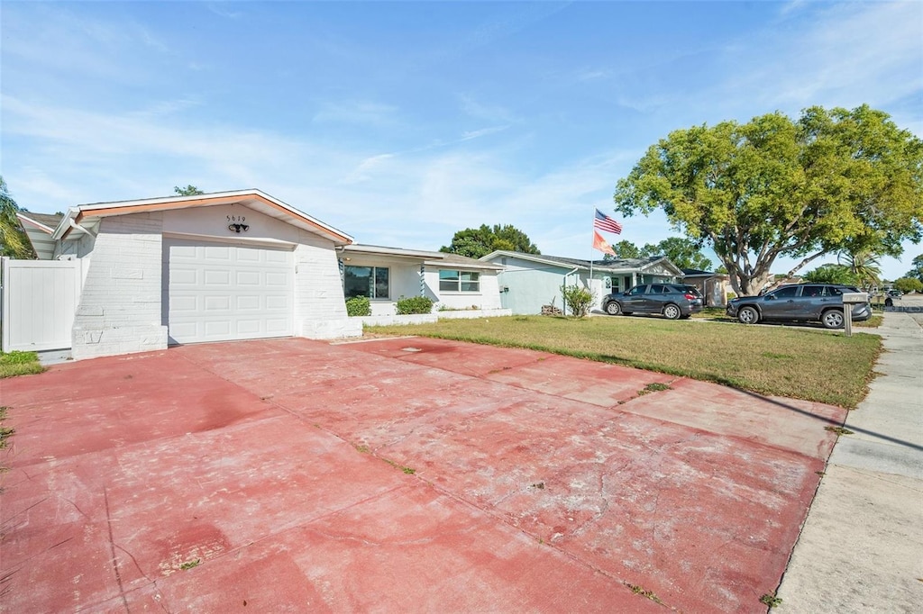 view of front of property featuring a garage and a front lawn