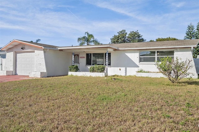 ranch-style home with a front lawn and a garage