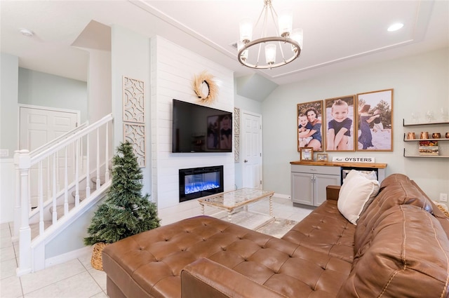 tiled living room with a notable chandelier