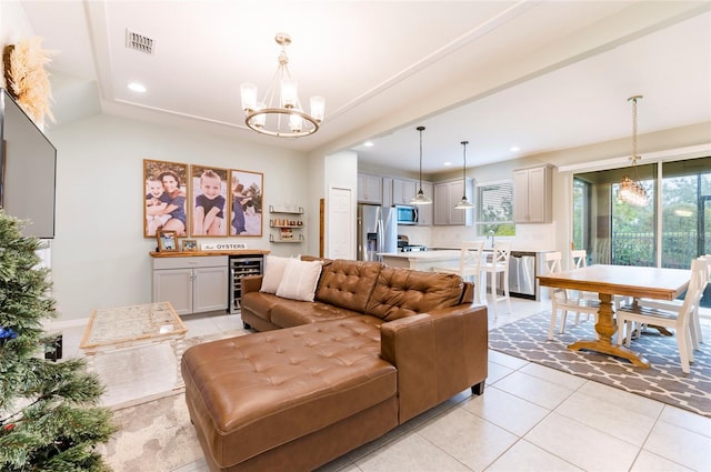 tiled living room featuring a notable chandelier and beverage cooler