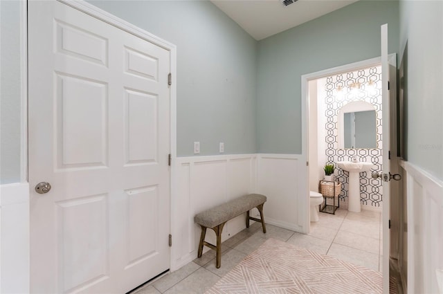 hall featuring light tile patterned flooring