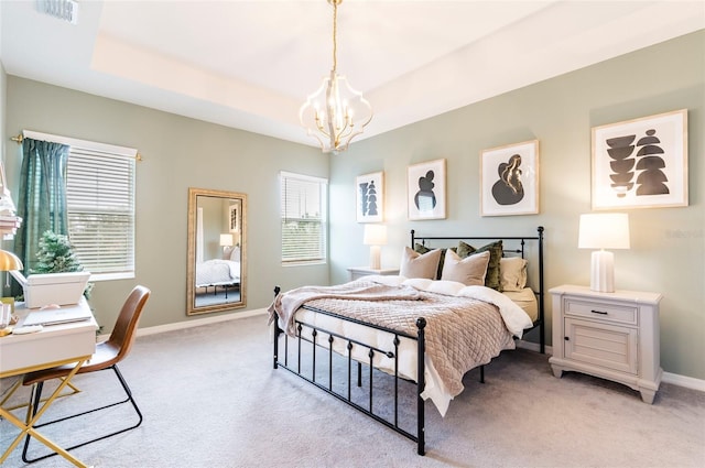 bedroom featuring an inviting chandelier, light colored carpet, and a raised ceiling