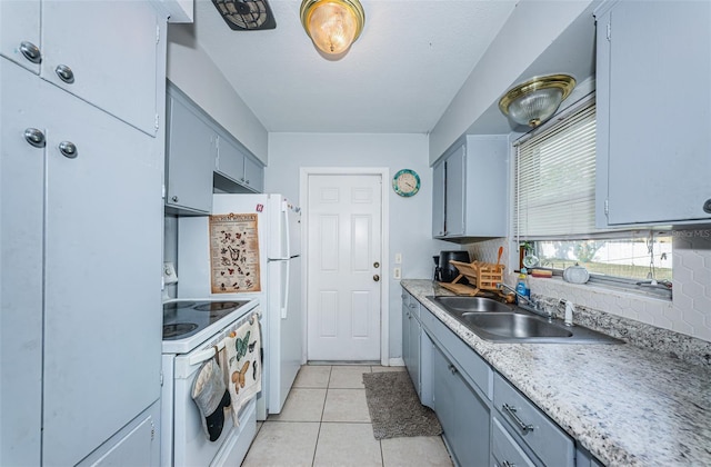 kitchen with white range with electric cooktop, backsplash, light tile patterned floors, and sink