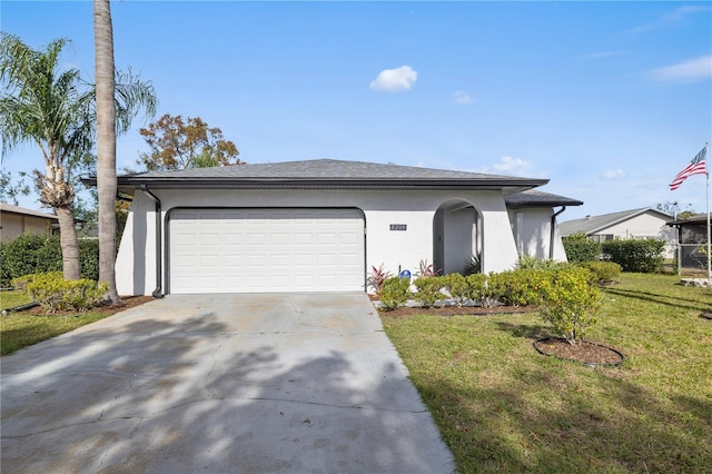 view of front of house featuring a front yard and a garage