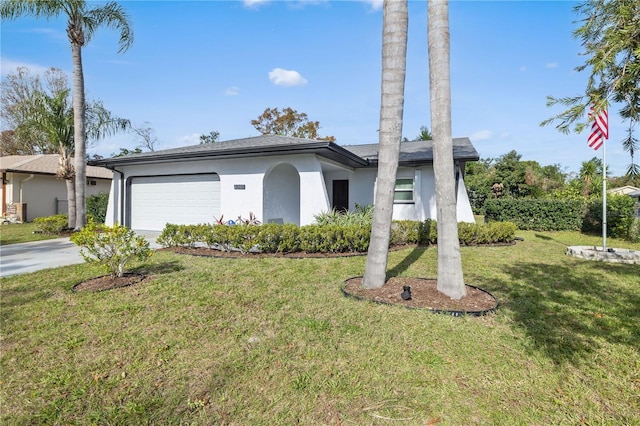 view of front of home with a garage and a front lawn