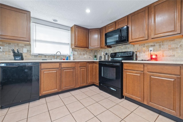 kitchen with a textured ceiling, sink, tasteful backsplash, and black appliances