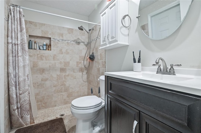 bathroom with a shower with shower curtain, vanity, and toilet