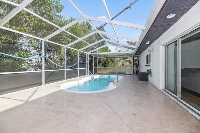 view of pool with a patio and a lanai