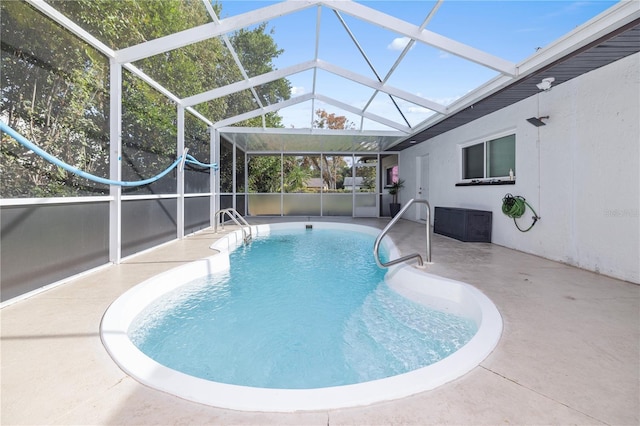 view of pool featuring a lanai and a patio