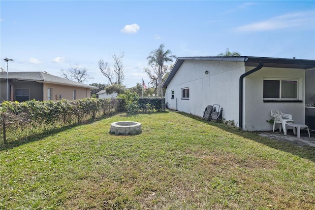 view of yard with an outdoor fire pit