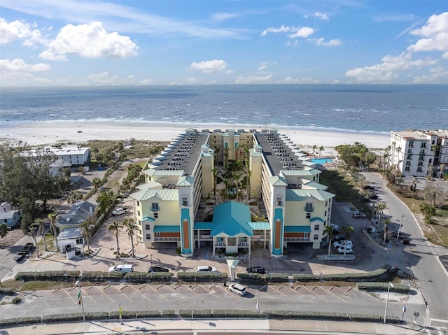 drone / aerial view featuring a beach view and a water view