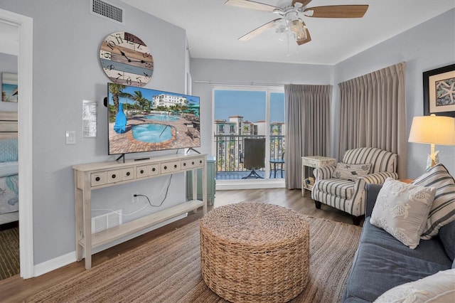 living room featuring dark hardwood / wood-style floors and ceiling fan