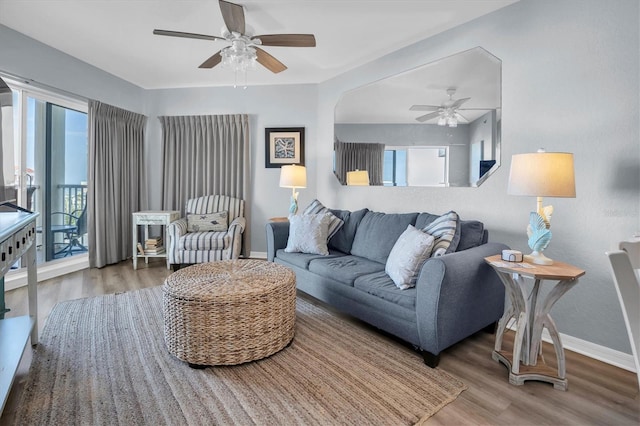 living room with hardwood / wood-style flooring and ceiling fan