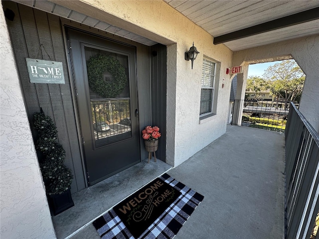 view of exterior entry with a porch