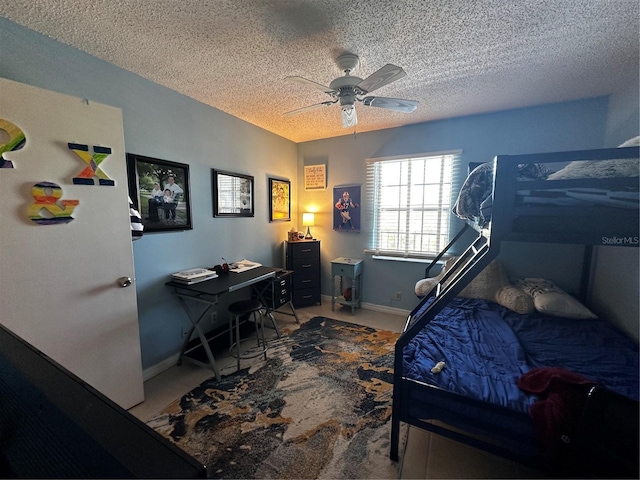 bedroom with ceiling fan and a textured ceiling