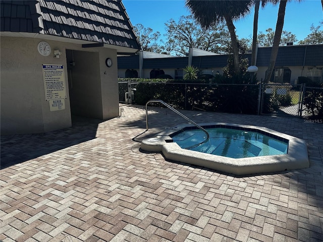 view of pool with a hot tub