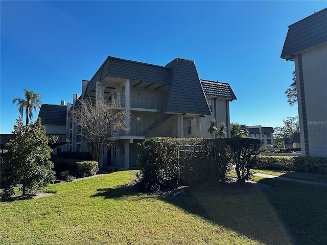 back of house with a lawn