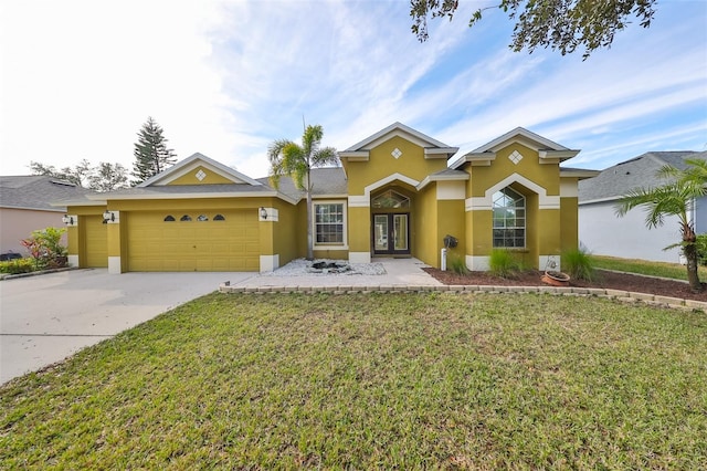 view of front facade featuring driveway, stucco siding, an attached garage, french doors, and a front yard