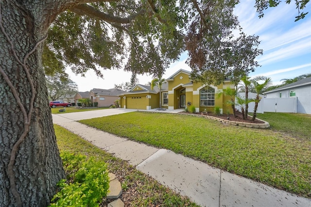 ranch-style home with a front yard and a garage