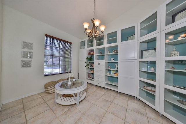 tiled dining space featuring vaulted ceiling and an inviting chandelier