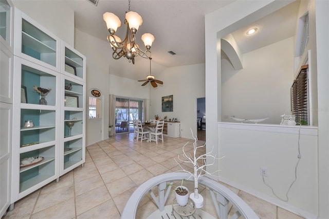 interior space with vaulted ceiling and ceiling fan with notable chandelier