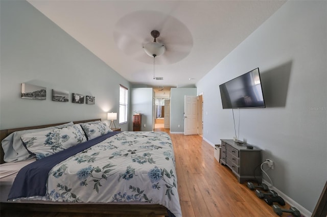 bedroom with ceiling fan, light wood-type flooring, and connected bathroom