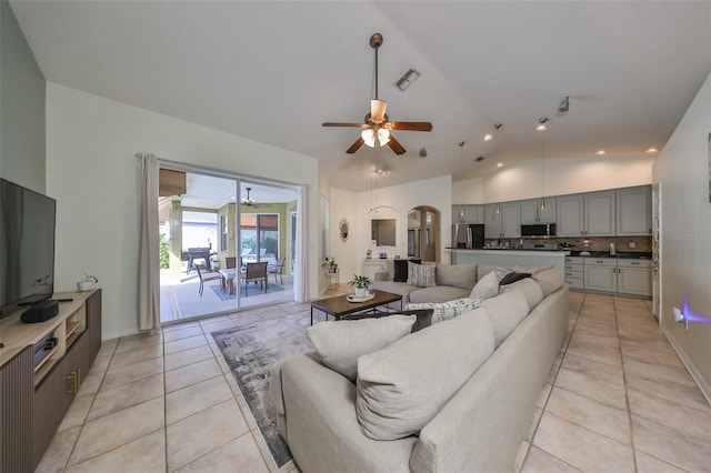 living room featuring ceiling fan, light tile patterned flooring, and high vaulted ceiling