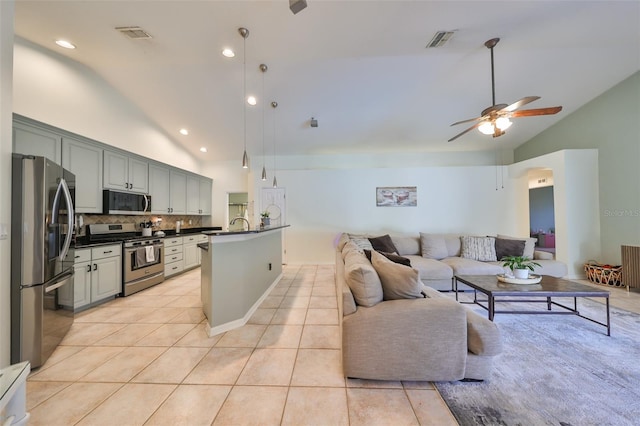 kitchen featuring tasteful backsplash, stainless steel appliances, vaulted ceiling, ceiling fan, and gray cabinets