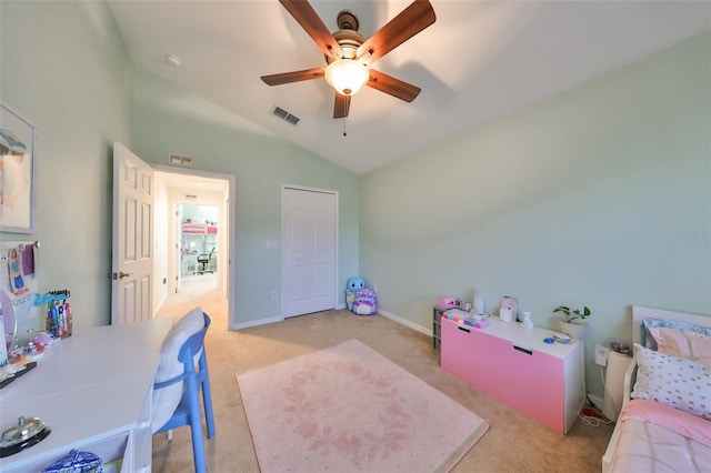 carpeted bedroom featuring a closet, vaulted ceiling, and ceiling fan