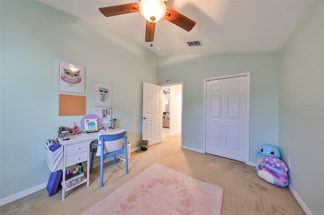 home office featuring ceiling fan, light carpet, and vaulted ceiling