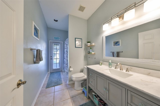 bathroom featuring tile patterned floors, vanity, and toilet