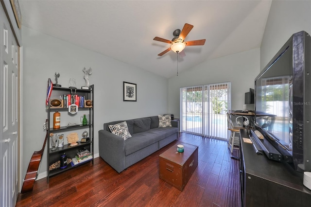 living room with ceiling fan, lofted ceiling, and dark wood-type flooring