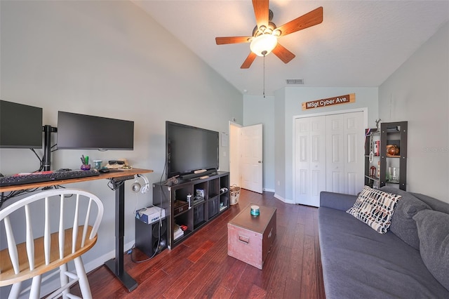 living room featuring ceiling fan, dark wood-type flooring, and lofted ceiling